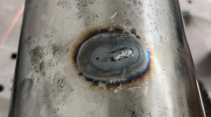 A photo of the air filter housing after the hole was welded shut.