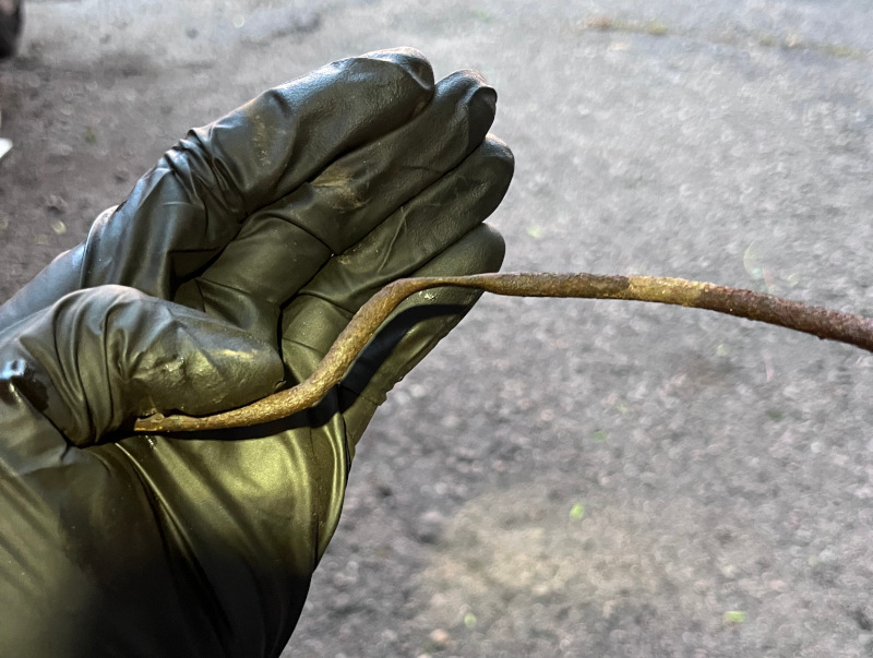 A photo showing the crushed brake hard line