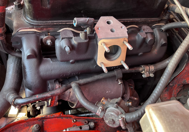 A photo of the manifold and catalytic converter assembly installed in the engine bay.
