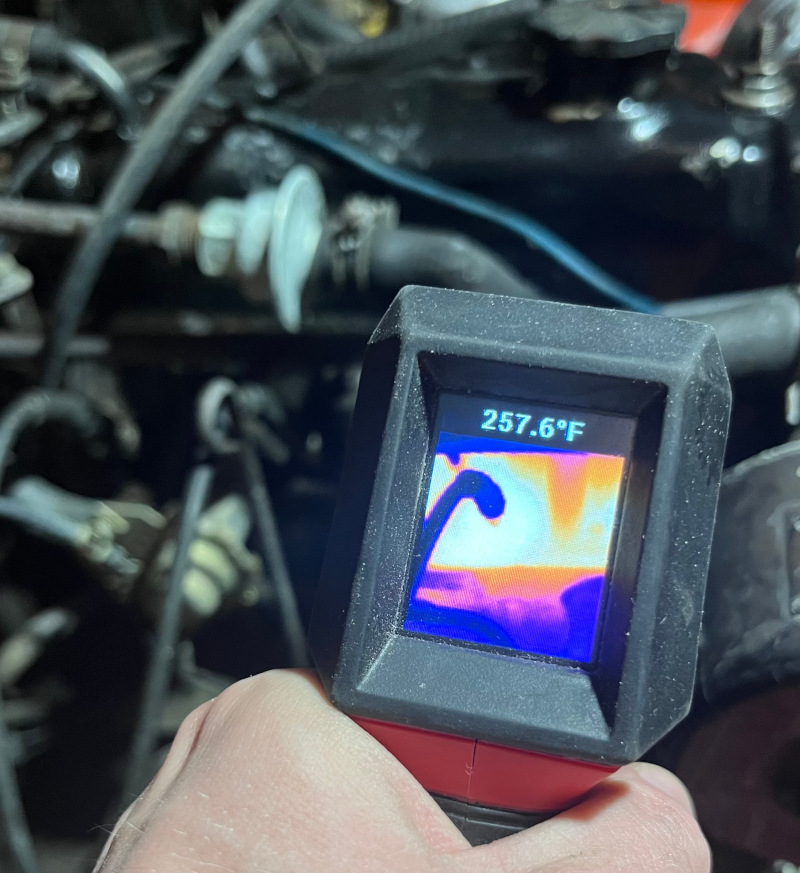 A photo showing the use of a thermal camera to measure the temperature of the MGB cylinder head. The thermal camera indicates that the head is at a temperature of 257.6 Fahrenheit.